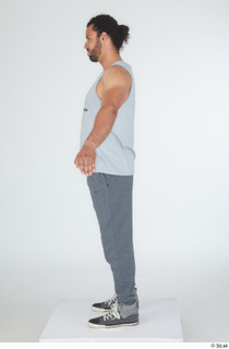 Simeon A poses dressed grey joggers grey sneakers grey tank…